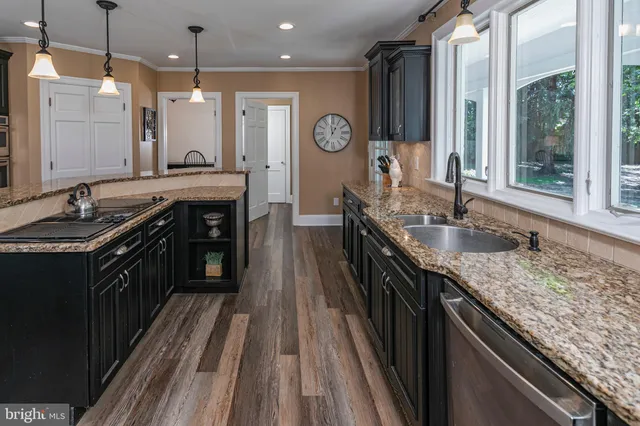 a bathroom with a sink a mirror and a window