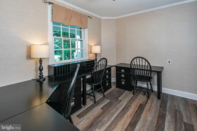 a view of hallway with closet and wooden door