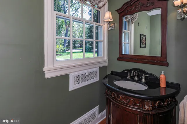 a bathroom with a double vanity sink and a mirror