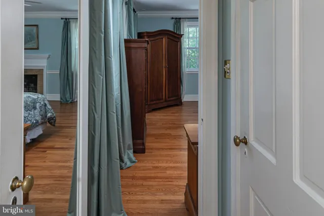 a bathroom with a granite countertop sink a mirror and a toilet