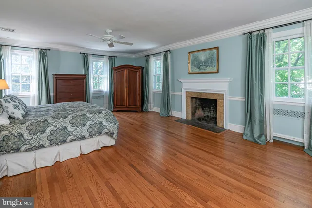 a spacious bedroom with a bed and a window