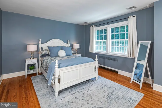 a bathroom with a granite countertop sink toilet and a mirror