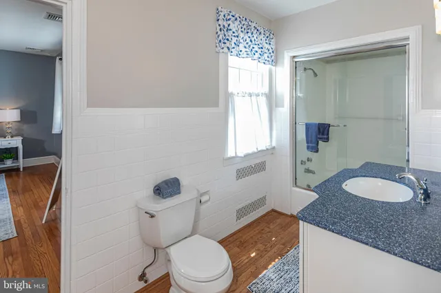 a living room with furniture and a dresser