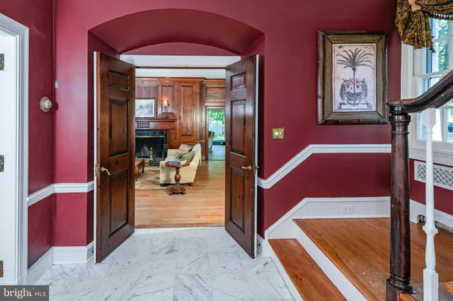a living room with furniture a fireplace and a floor to ceiling window