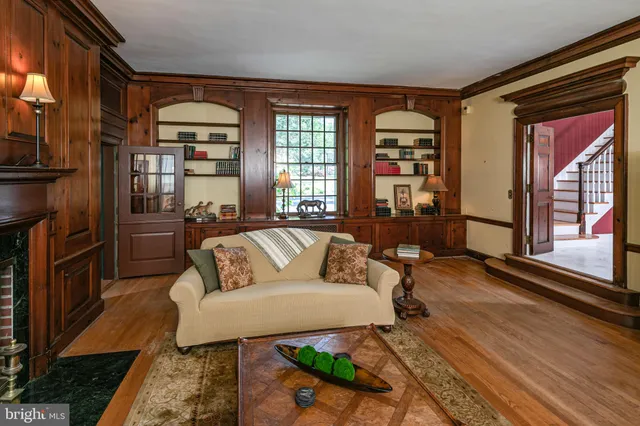 a living room with patio furniture and a large window