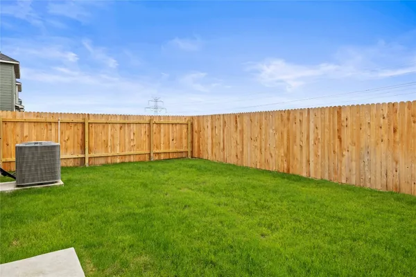 a view of yard with swimming pool and wooden fence