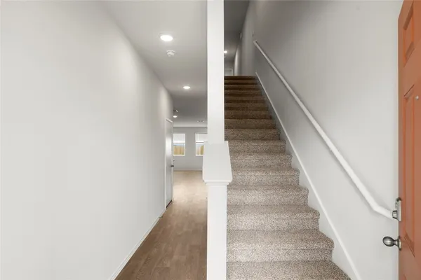 a view of entryway and hall with wooden floor