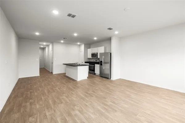 a view of kitchen with refrigerator sink and wooden floor