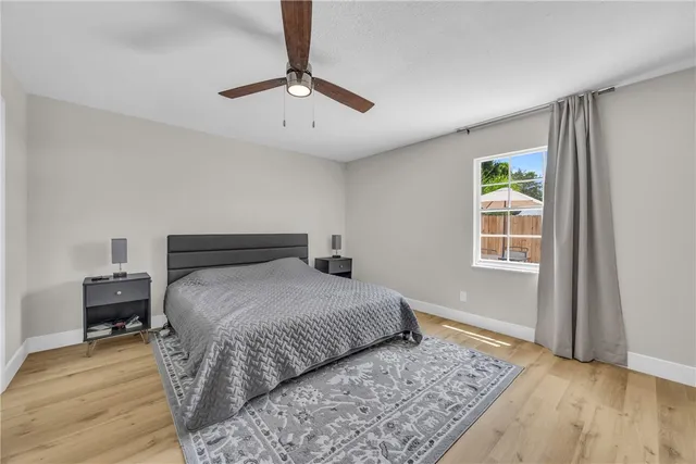 a bedroom with a bed and wooden floor