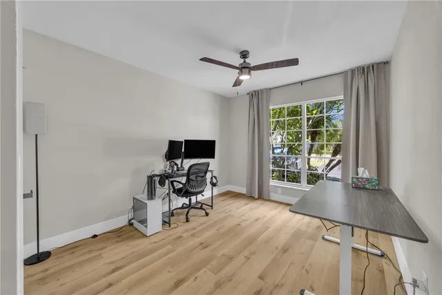 a view of a workspace with furniture and a window