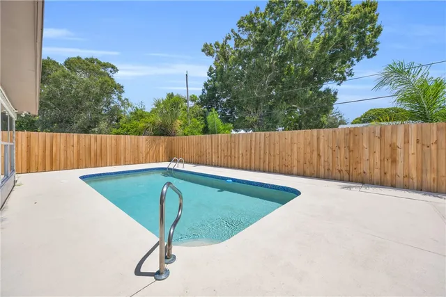 a view of a tennis ground with wooden fence