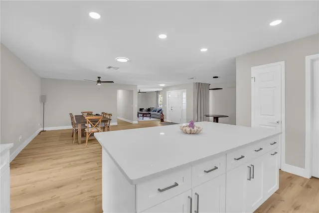 a view of dining table chairs and wooden floor