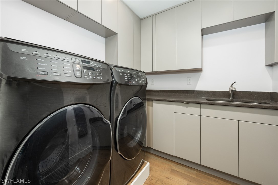939 Beach Road Sanibel, FL 33957 - Photo 16 of 32 a close view of a sink and a washer dryer
