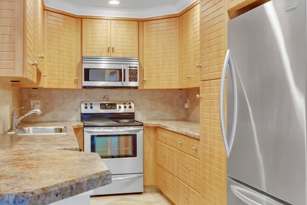 a kitchen with stainless steel appliances granite countertop a stove and a microwave
