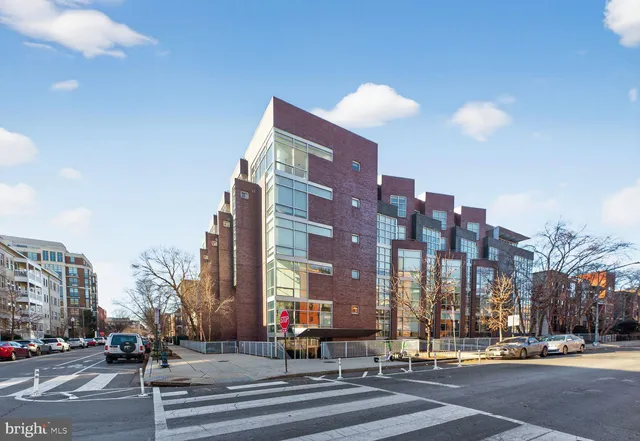 a view of a city street lined with buildings and trees