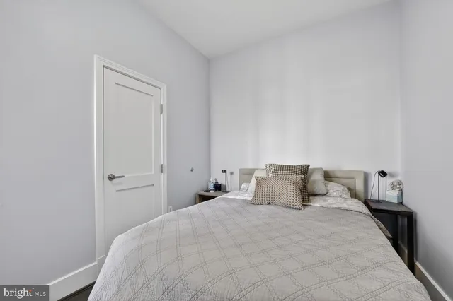 a bedroom with a bed and a night stand