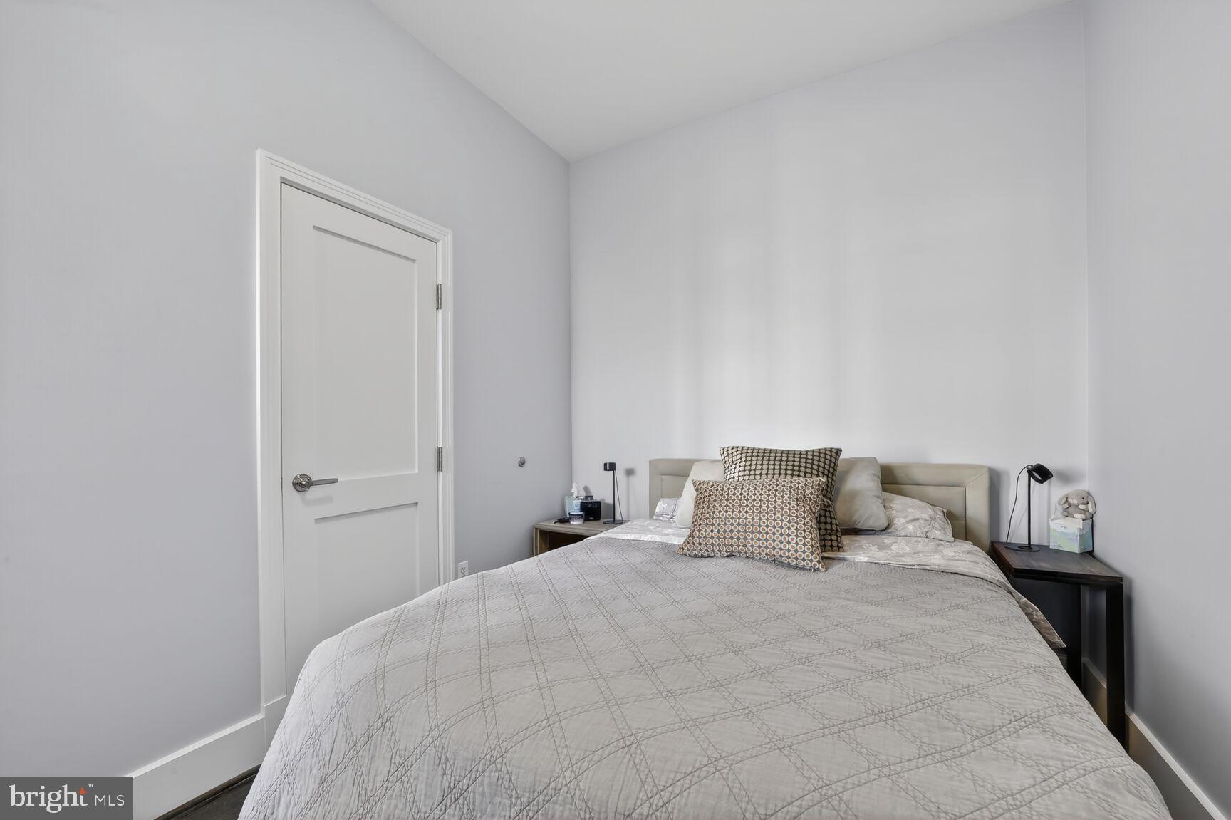 2100 11th Street Northwest, Unit 402 Washington, DC 20001 - Photo 11 of 14 a bedroom with a bed and a night stand