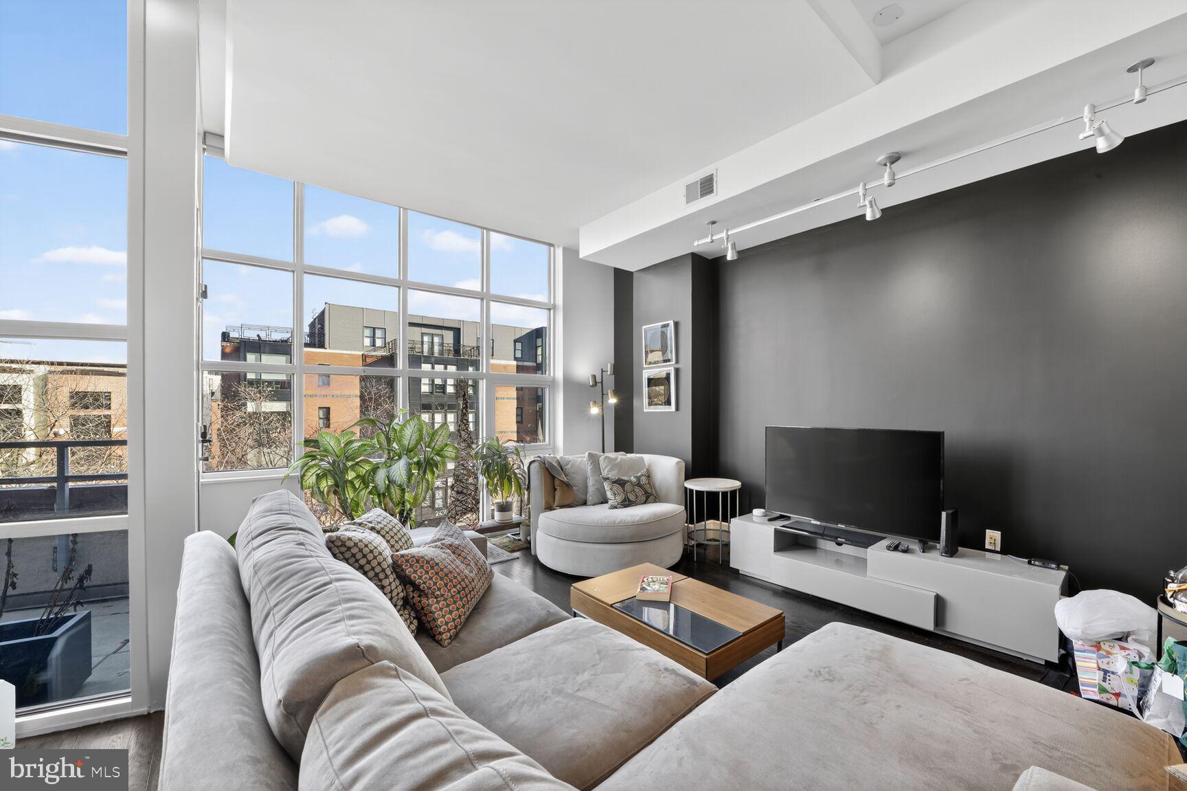 2100 11th Street Northwest, Unit 402 Washington, DC 20001 - Photo 5 of 14 a living room with furniture and a flat screen tv