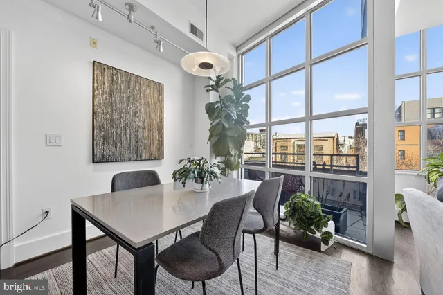 a view of a dining room with furniture window and wooden floor