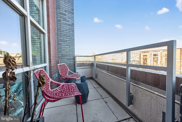 a view of a chairs and table in the balcony