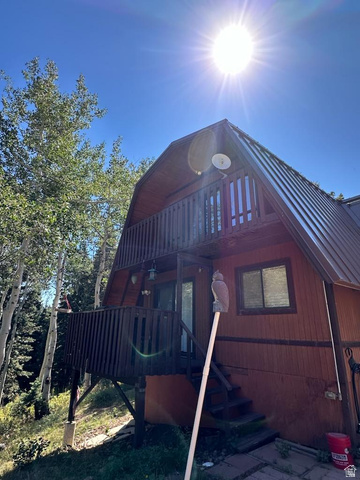 1456 Navajo Road Coalville, UT 84017 - Photo 48 of 55 View of side of home featuring a gambrel roof, a balcony, and a wooden deck