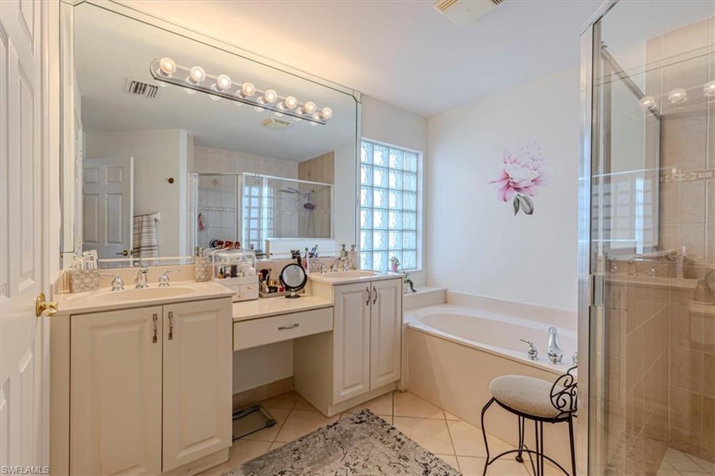 1630 Triangle Palm Terrace Naples, FL 34119 - Photo 15 of 24 a bathroom with a tub sink and mirror