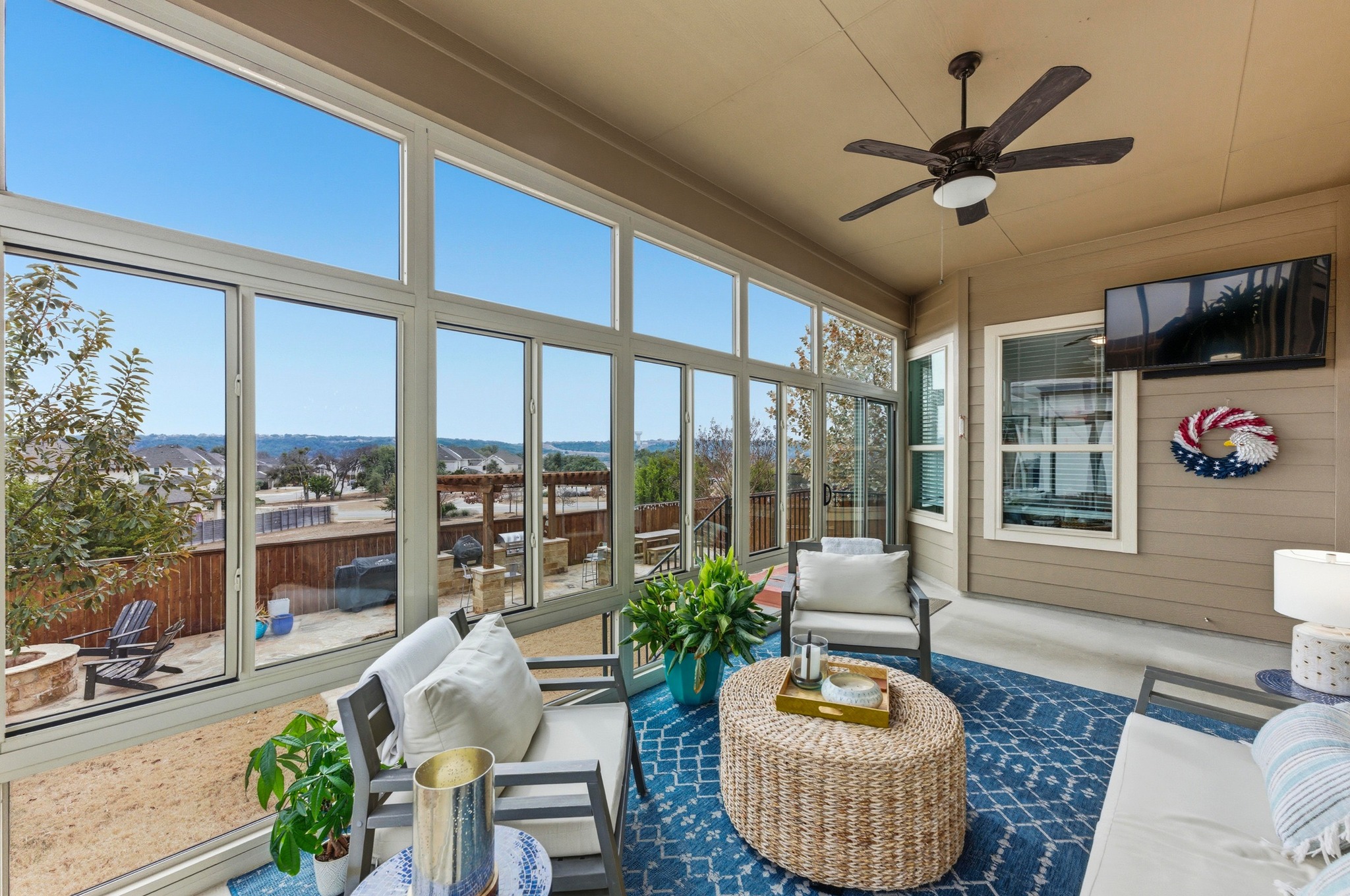 a living room with furniture and a floor to ceiling window