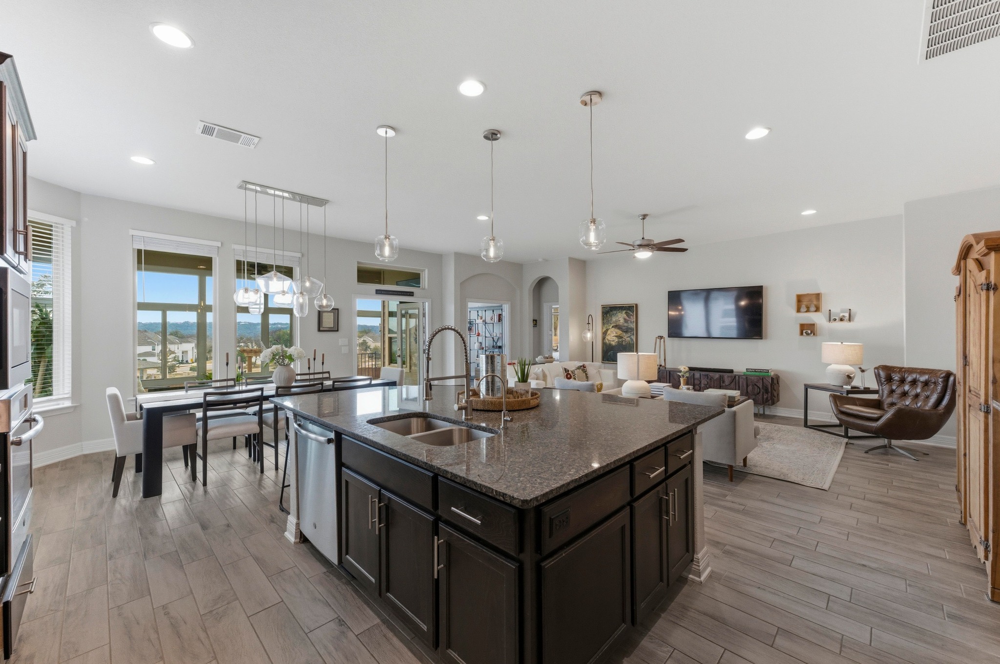 348 Panzano Drive Georgetown, TX 78628 - Photo 16 of 35 a kitchen with stainless steel appliances granite countertop a table chairs stove and wooden floor