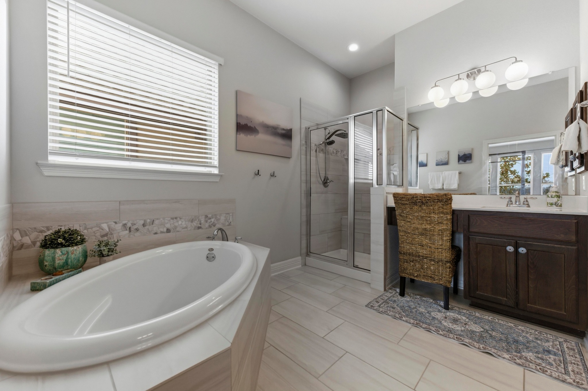 348 Panzano Drive Georgetown, TX 78628 - Photo 19 of 35 a white bath tub sitting in a bathroom and mirror