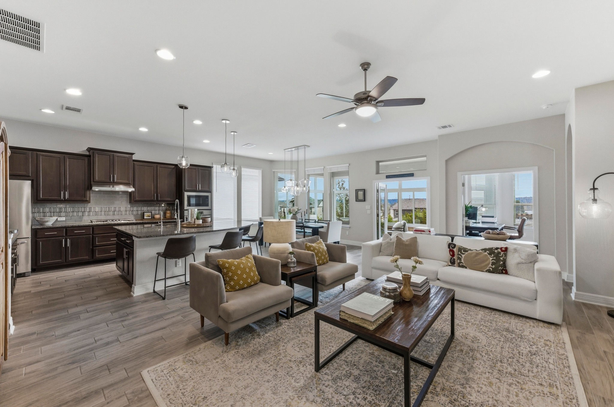 348 Panzano Drive Georgetown, TX 78628 - Photo 2 of 35 a living room with furniture kitchen view and a chandelier