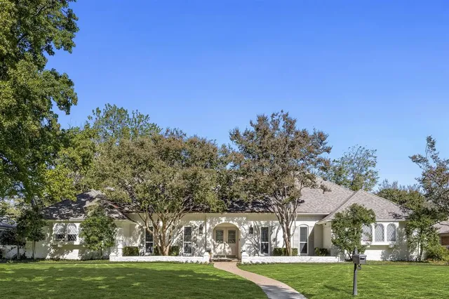 a view of a city with tall trees