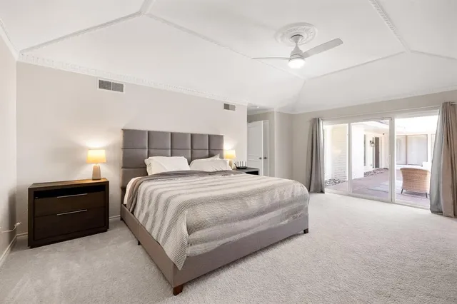 a spacious bedroom with a bed and a dresser