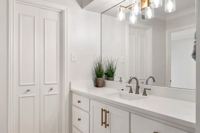 a bathroom with a sink a vanity and a mirror