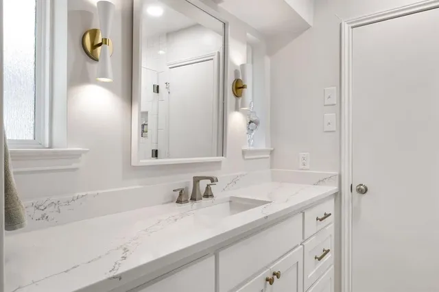 a bathroom with a sink and a mirror
