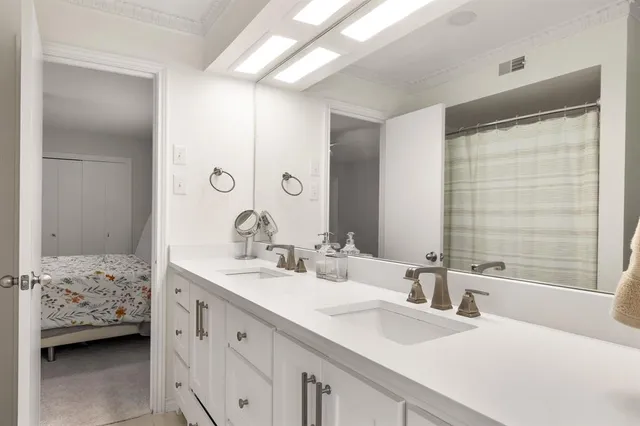 a bathroom with a sink double vanity and a bathtub