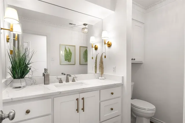 a bathroom with a sink a toilet and a mirror