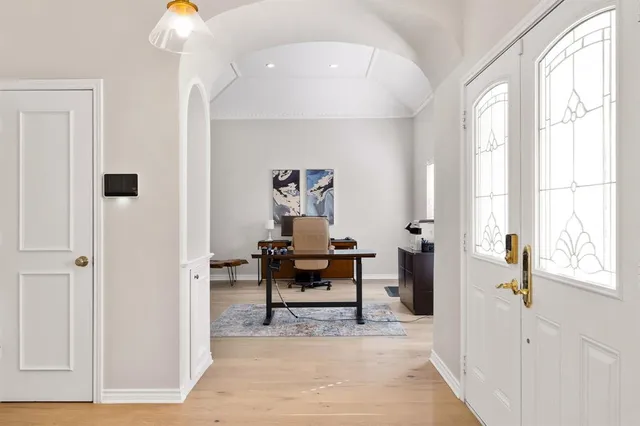 a living room with furniture a piano and a window