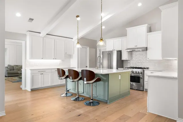 a kitchen with a sink cabinets and window