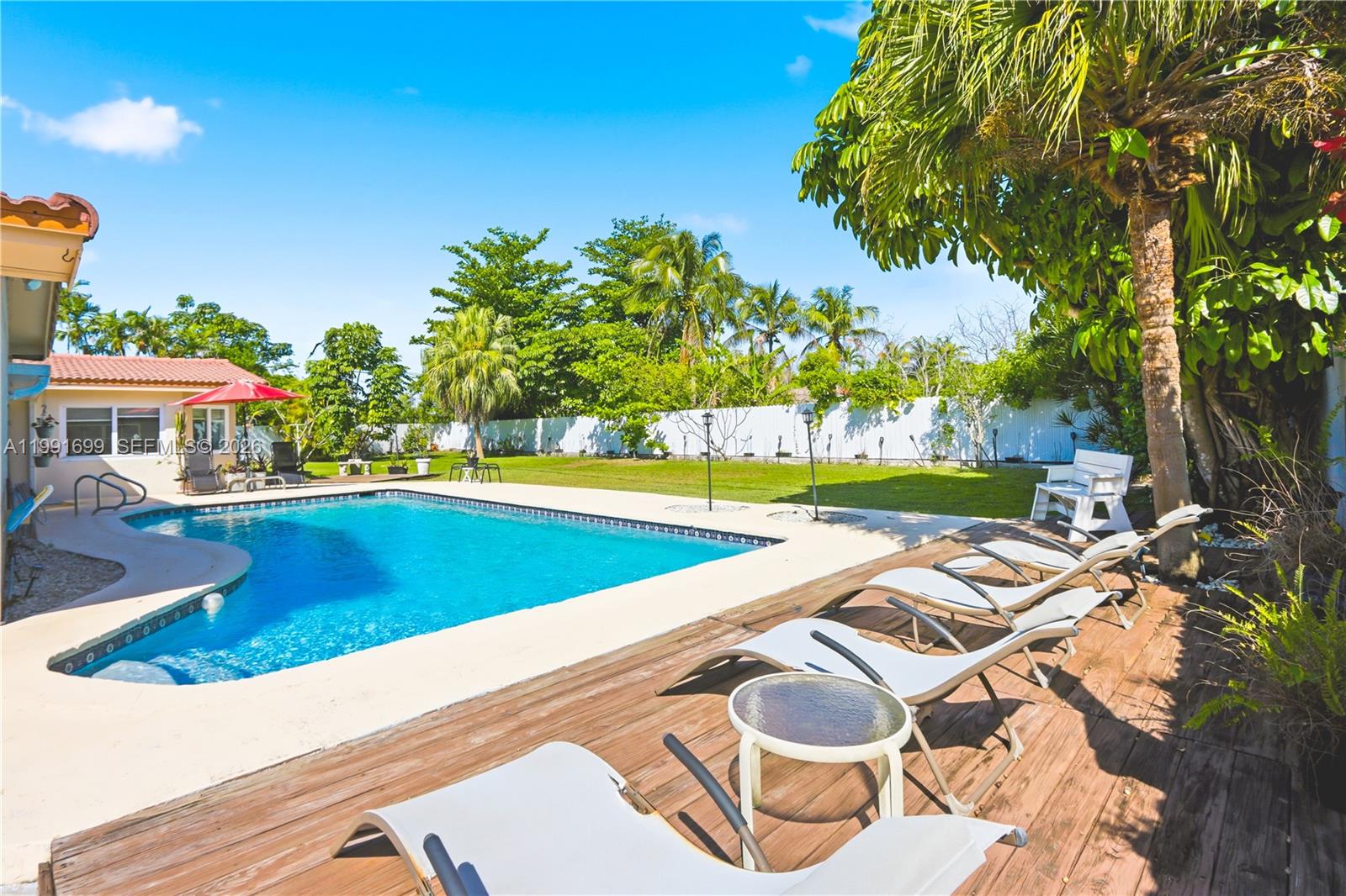 a view of a house with swimming pool and sitting area