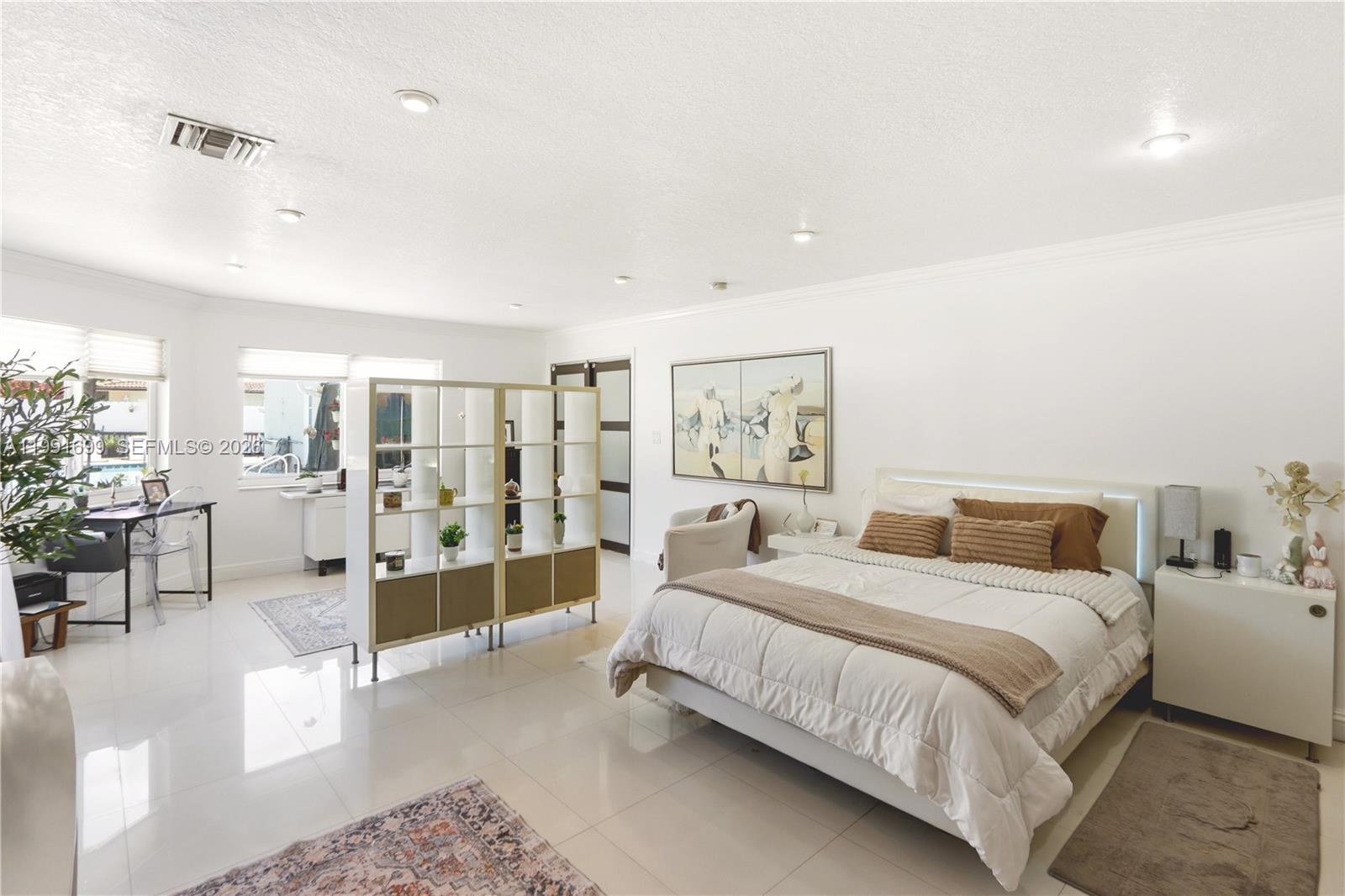 9955 Southwest 74th Street Miami, FL 33173 - Photo 11 of 28 a bedroom with a large bed and a view of bedroom