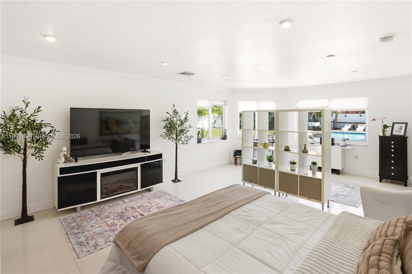 9955 Southwest 74th Street Miami, FL 33173 - Photo 12 of 28 a bedroom with a bed and a television in it