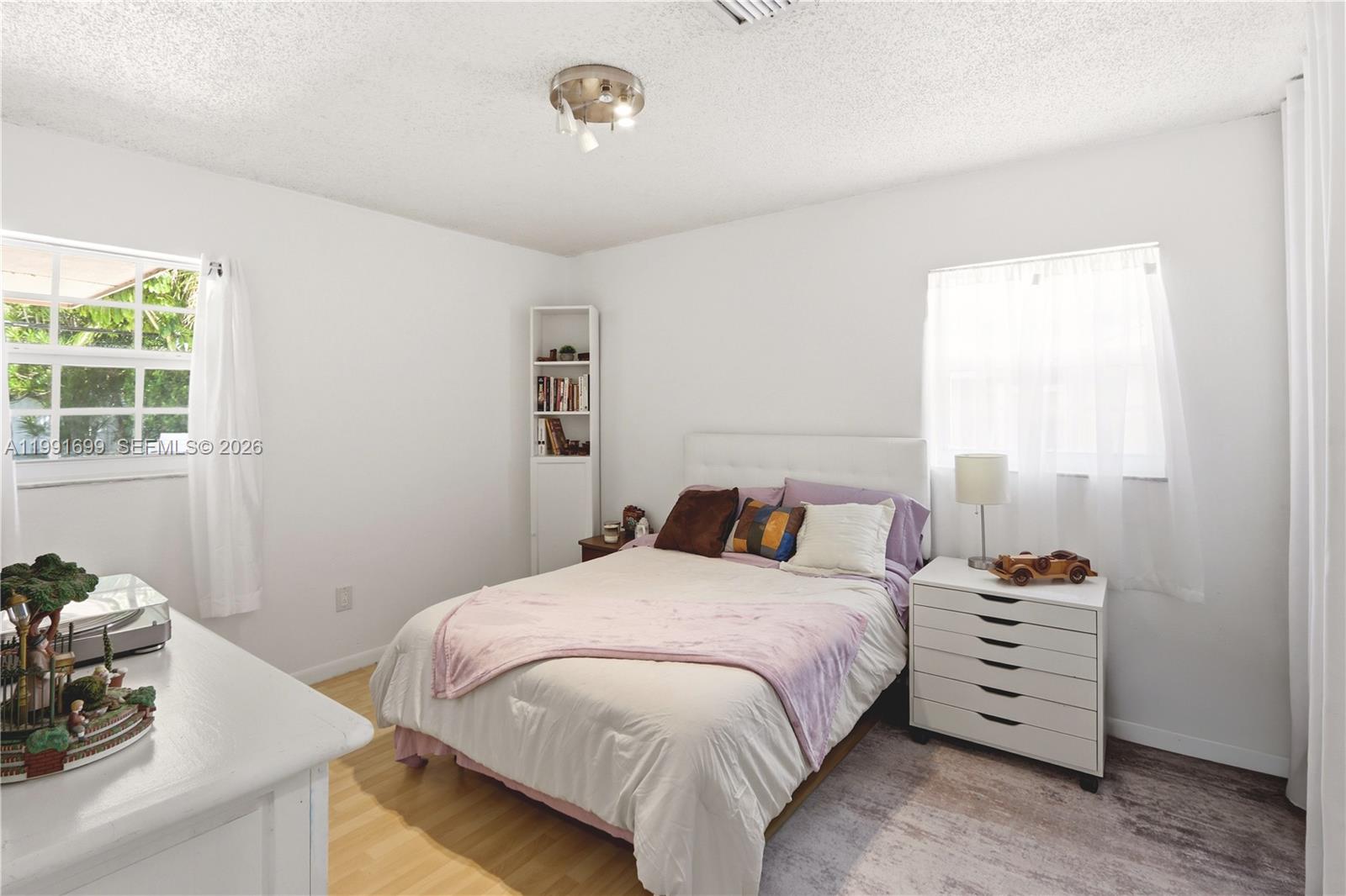 9955 Southwest 74th Street Miami, FL 33173 - Photo 19 of 28 a bedroom with a bed and a window