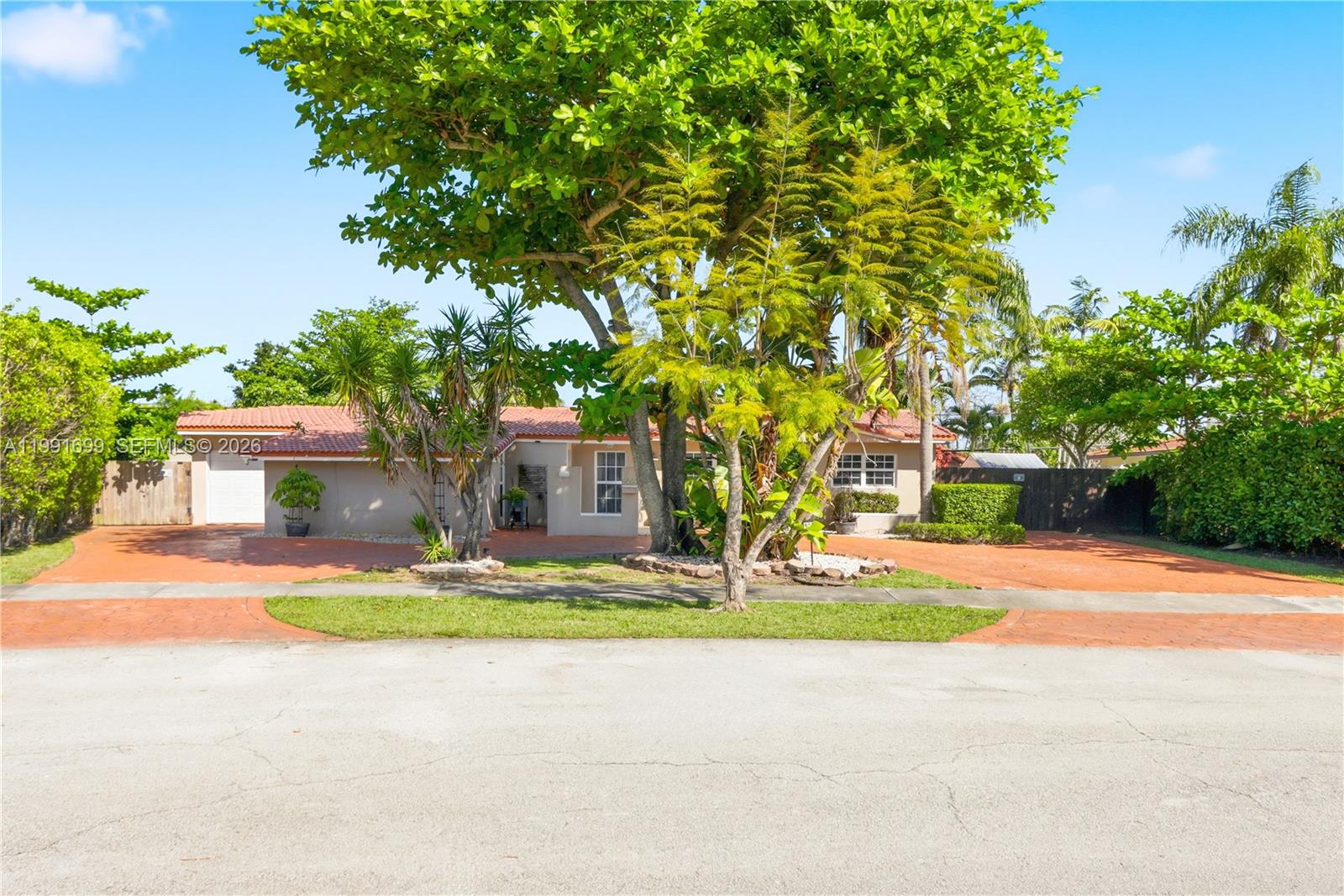 9955 Southwest 74th Street Miami, FL 33173 - Photo 3 of 28 a house with trees in front of it