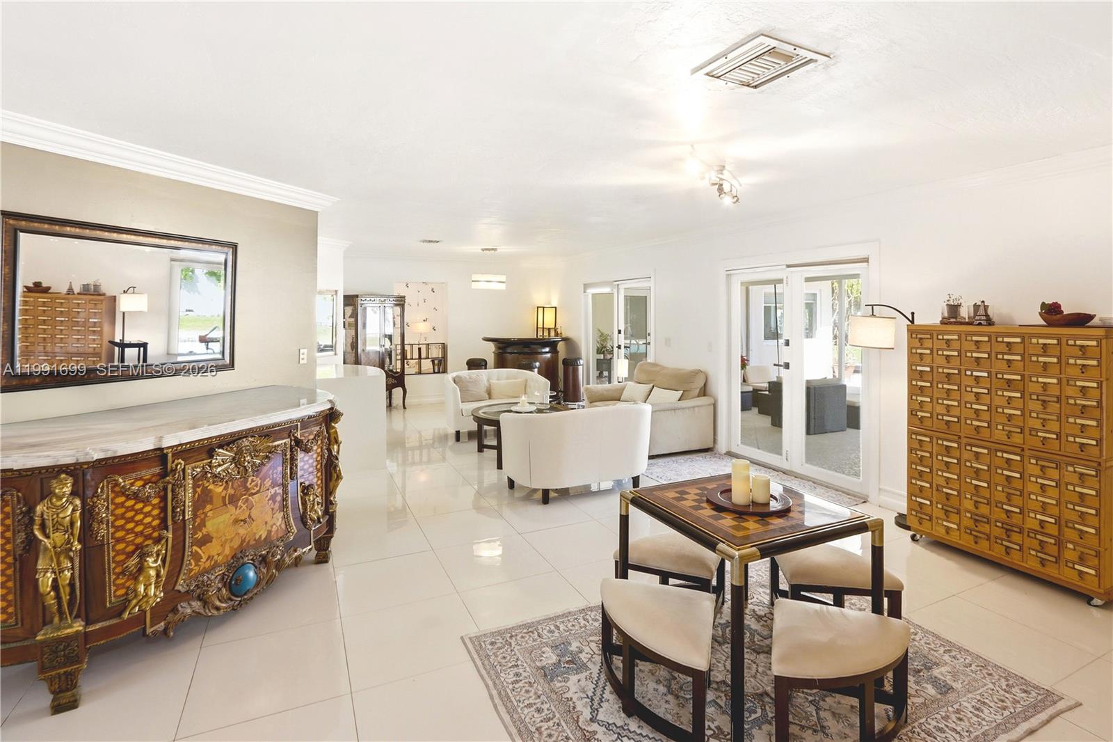 9955 Southwest 74th Street Miami, FL 33173 - Photo 4 of 28 a living room with furniture and a table