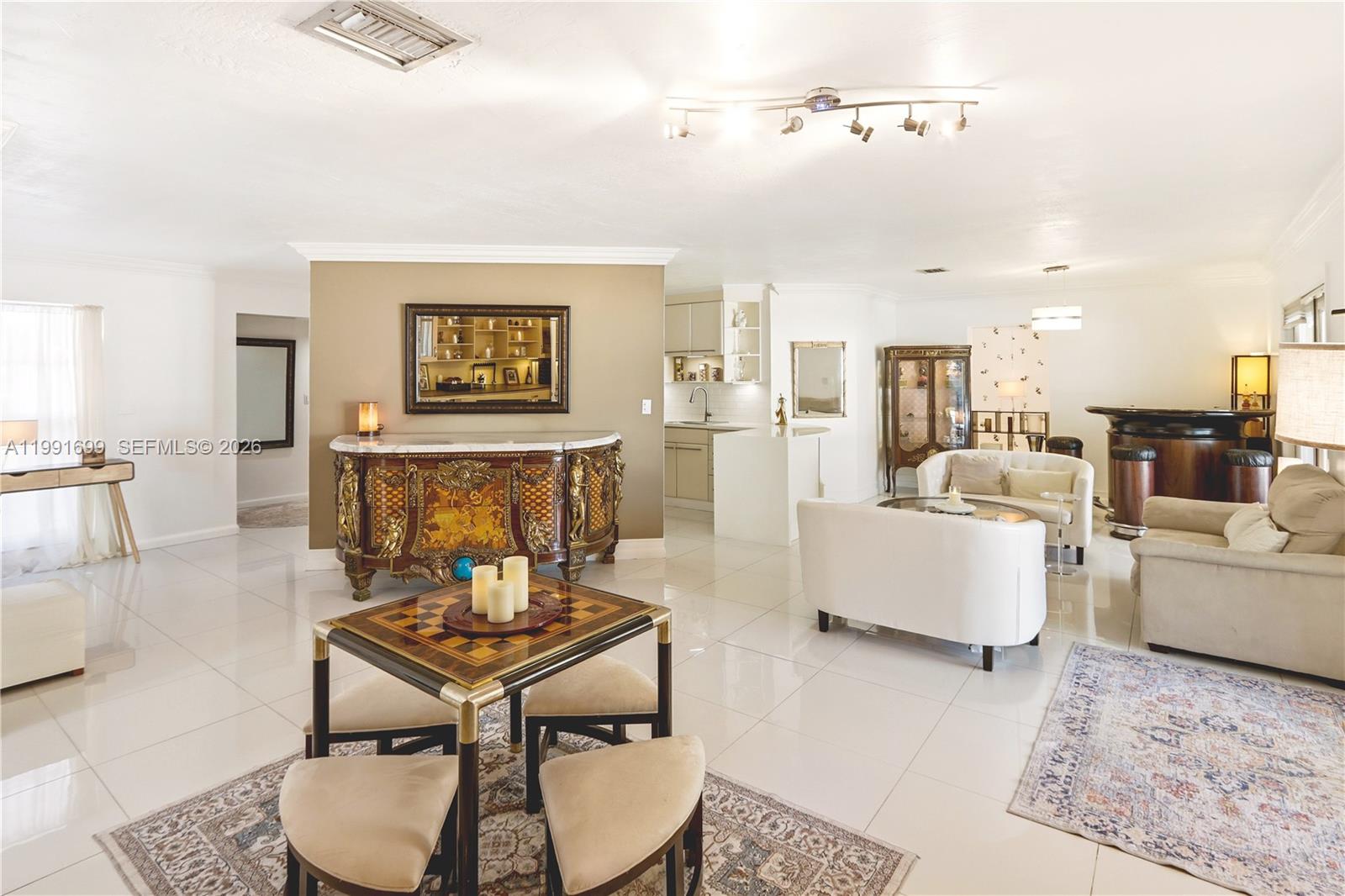 9955 Southwest 74th Street Miami, FL 33173 - Photo 5 of 28 a living room with furniture and a view of kitchen