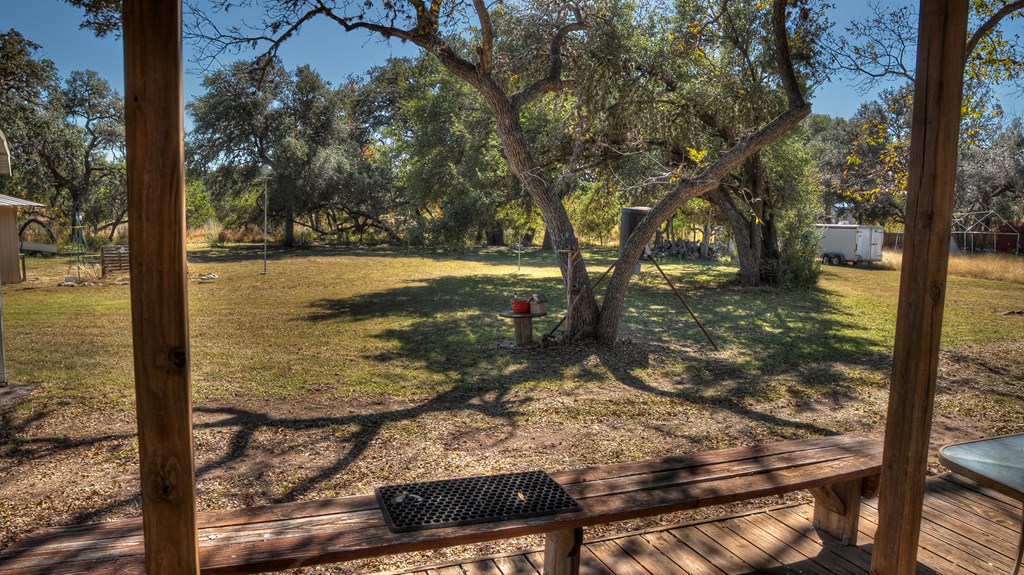 218 Trickling Creek Road Rio Frio, TX 78879 - Photo 15 of 39 a view of a yard with wooden fence