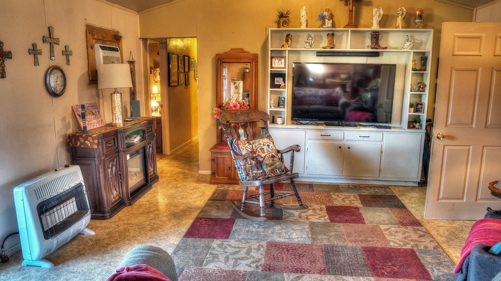 218 Trickling Creek Road Rio Frio, TX 78879 - Photo 22 of 39 a living room with patio furniture and a fireplace