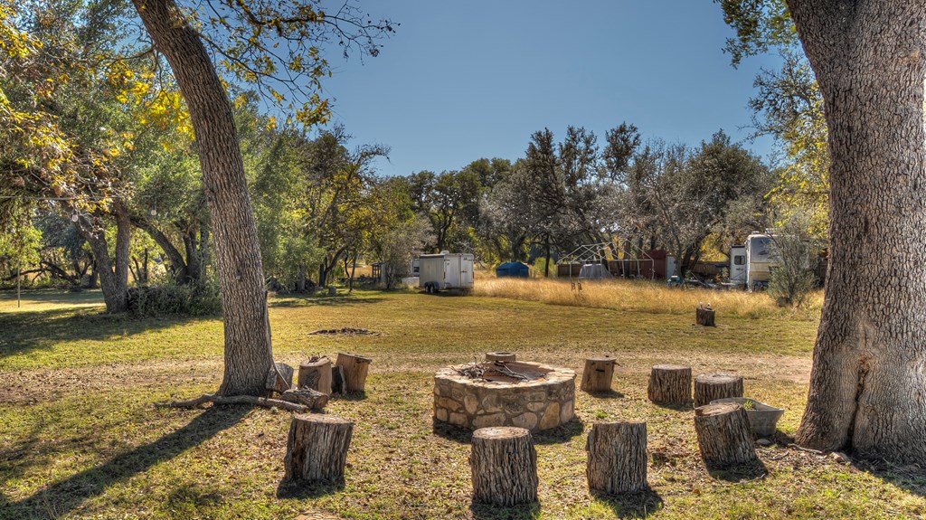 218 Trickling Creek Road Rio Frio, TX 78879 - Photo 6 of 39 a view of a lake with a table and chairs