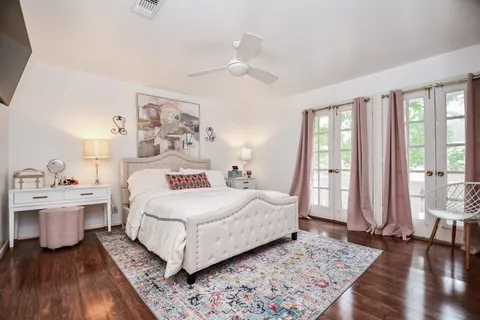 a bedroom with a bed and a large window
