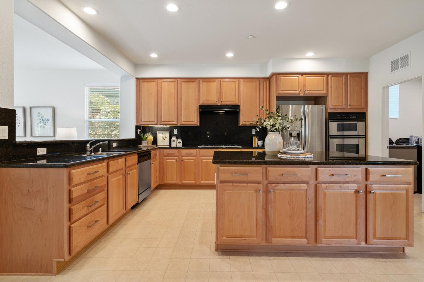 357 Pebble Beach Drive Brentwood, CA 94513 - Photo 20 of 56 a kitchen with stainless steel appliances granite countertop a sink a stove a refrigerator a center island and a window